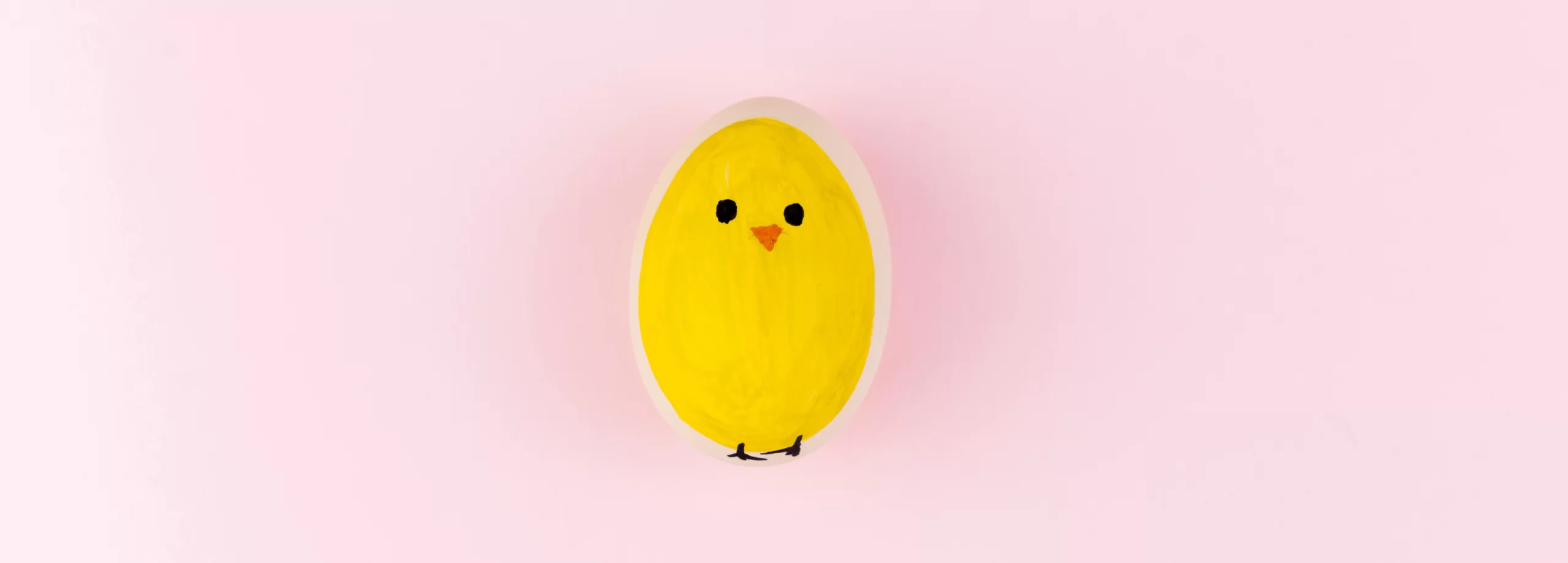 a yellow chick painted on an egg