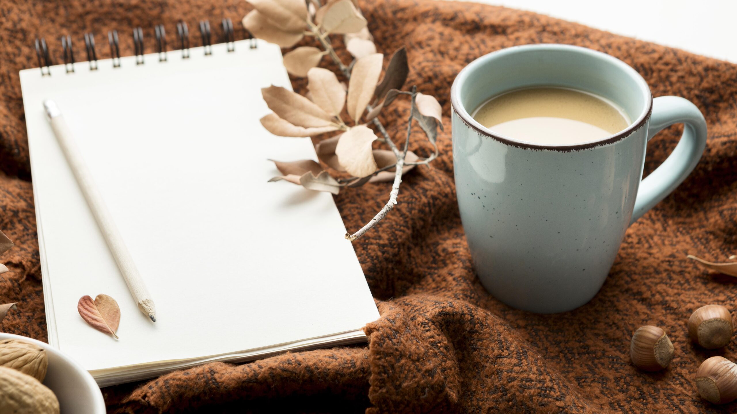 Writing tablet with mug of coffee on a table